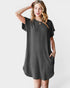 Woman wearing a black textured dress on a white background