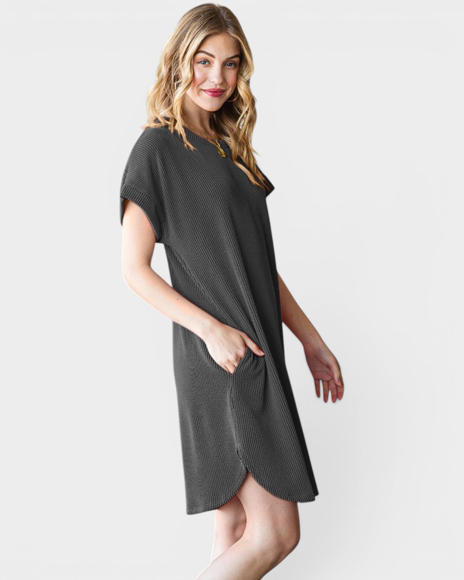 Woman wearing a black dress against a white background