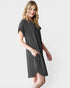 Woman wearing a black dress against a white background