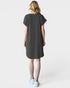 Woman wearing a dark gray t-shirt dress on a white background