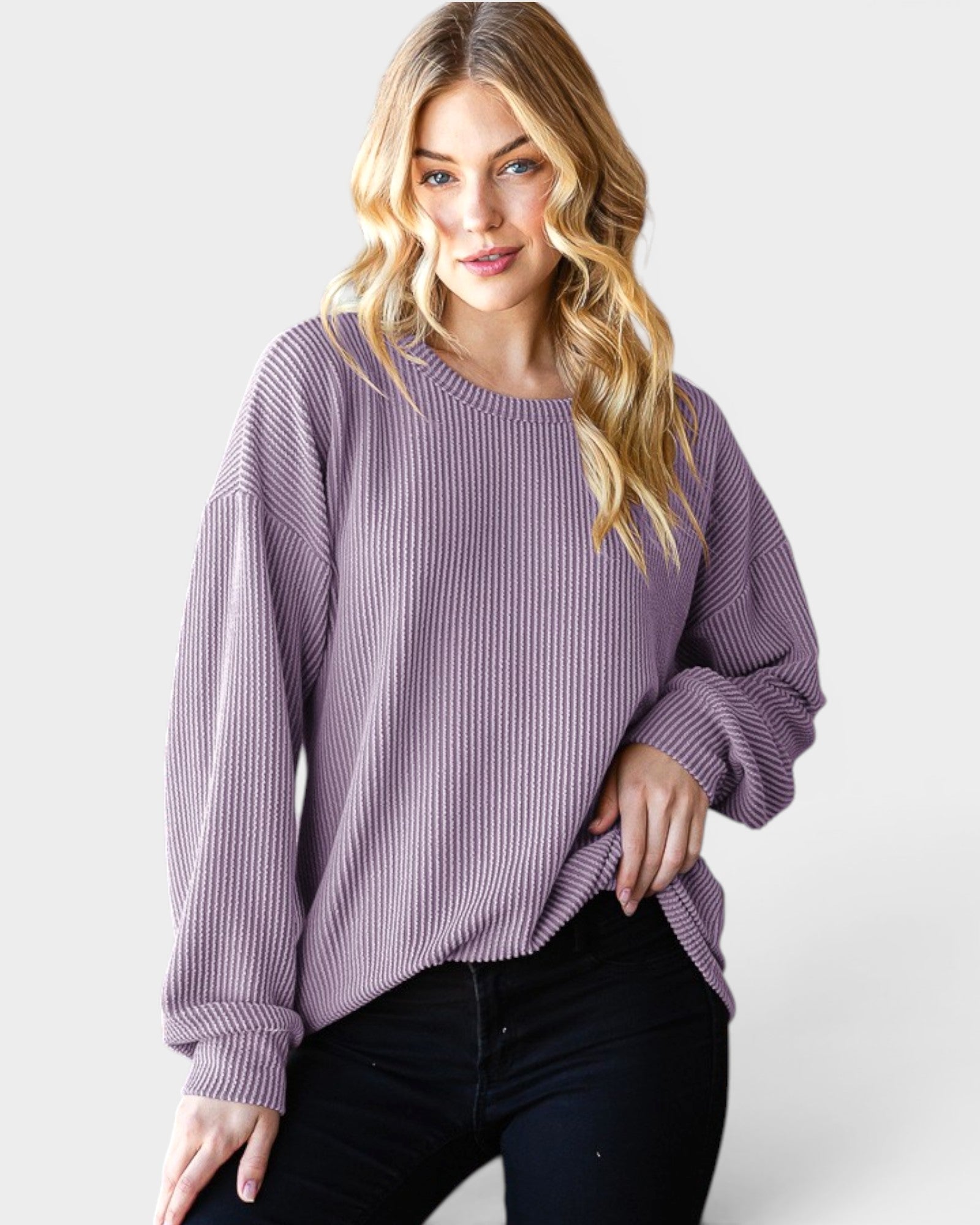 Woman wearing a purple sweater on a white background