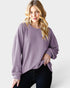 Woman wearing a purple sweater on a white background