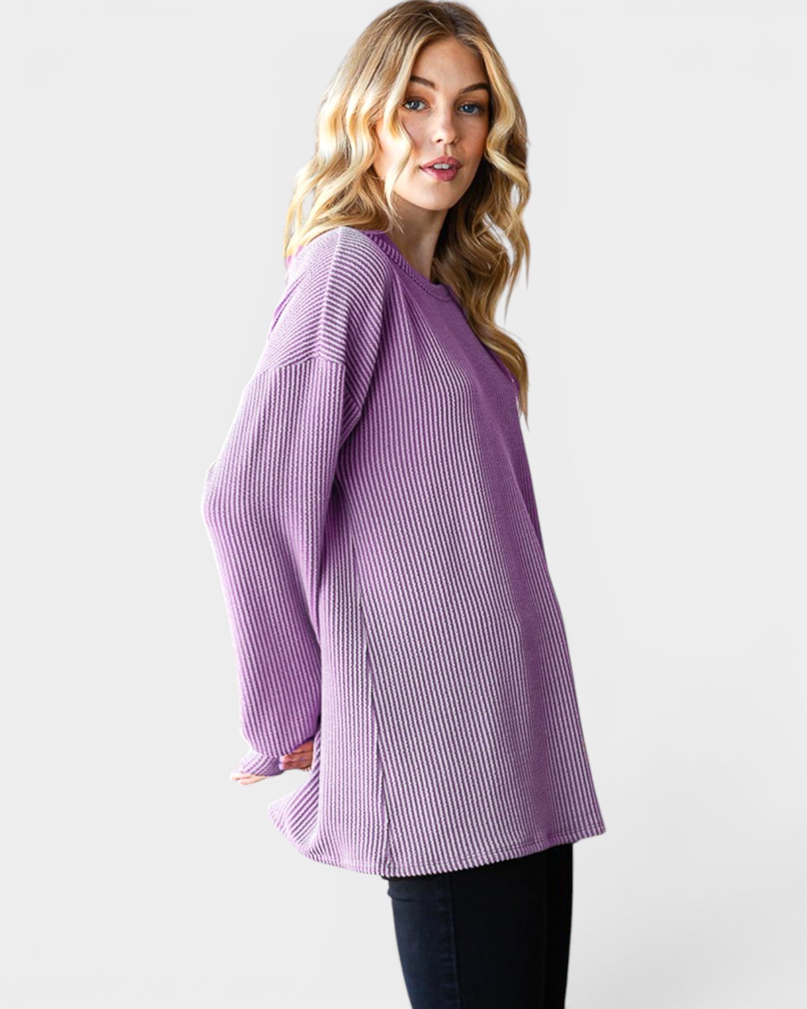Woman wearing a purple striped shirt against a white background