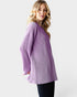 Woman wearing a purple striped shirt against a white background