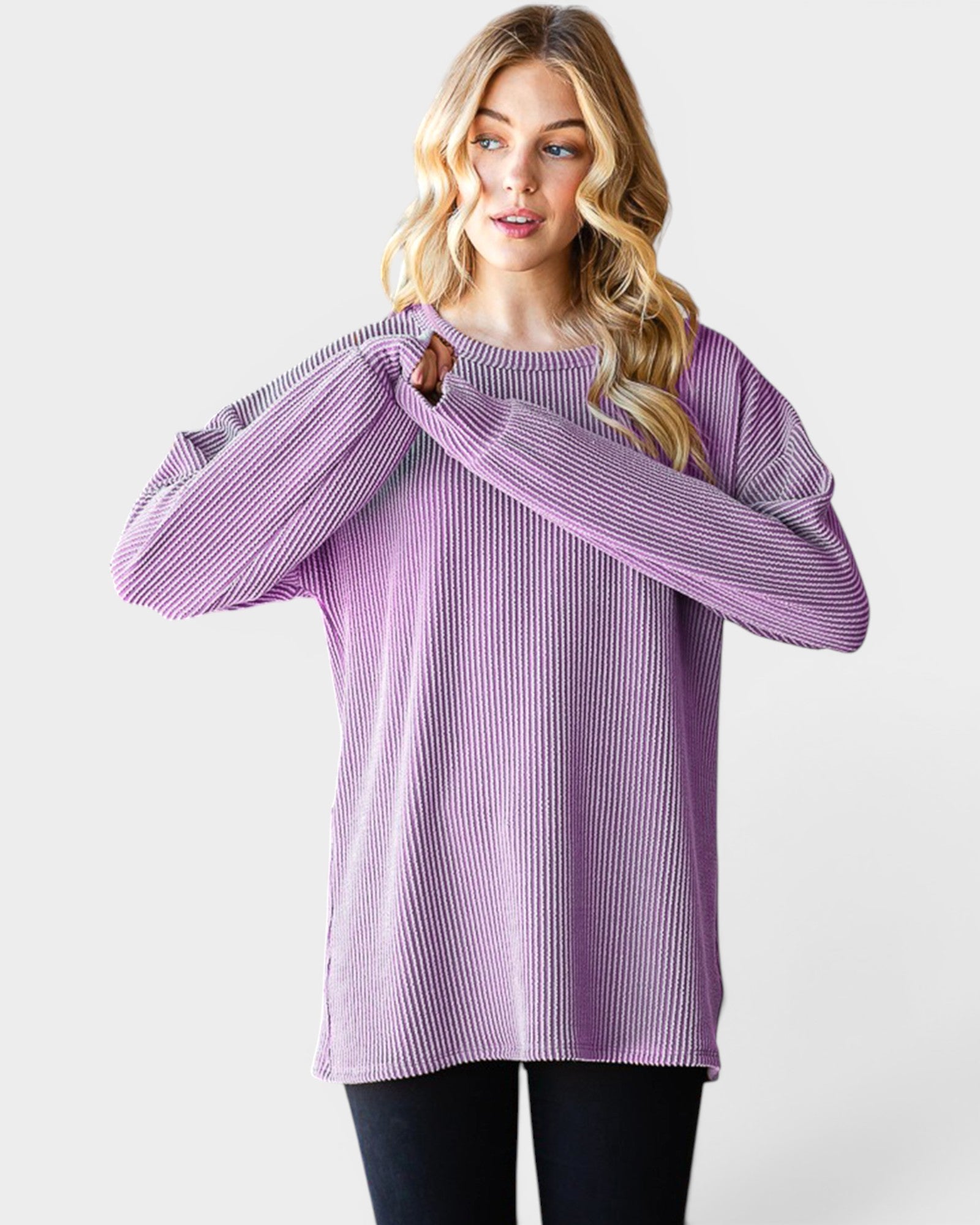 Woman wearing a purple ribbed sweater on a white background