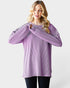Woman wearing a purple ribbed sweater on a white background