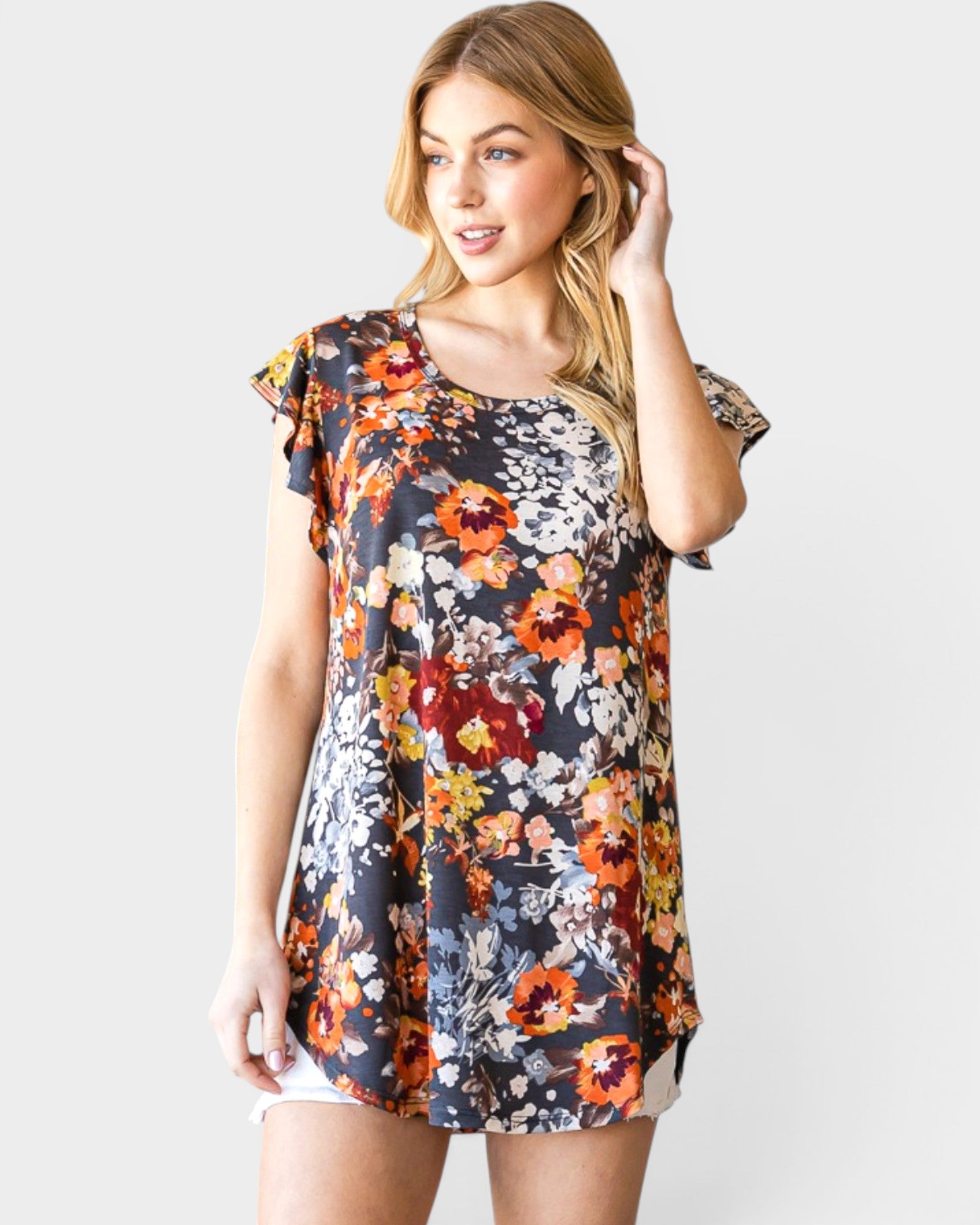 Woman wearing a floral dress on a plain background