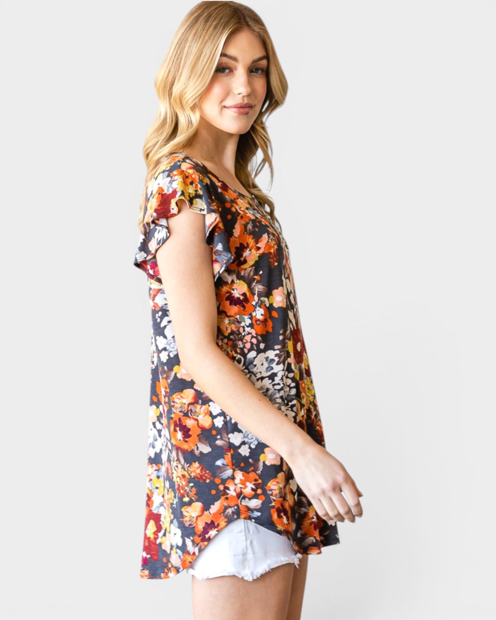 Woman wearing a floral print top on a white background