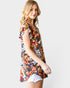 Woman wearing a floral print top on a white background