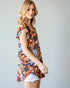 Woman wearing a floral dress with a plain background