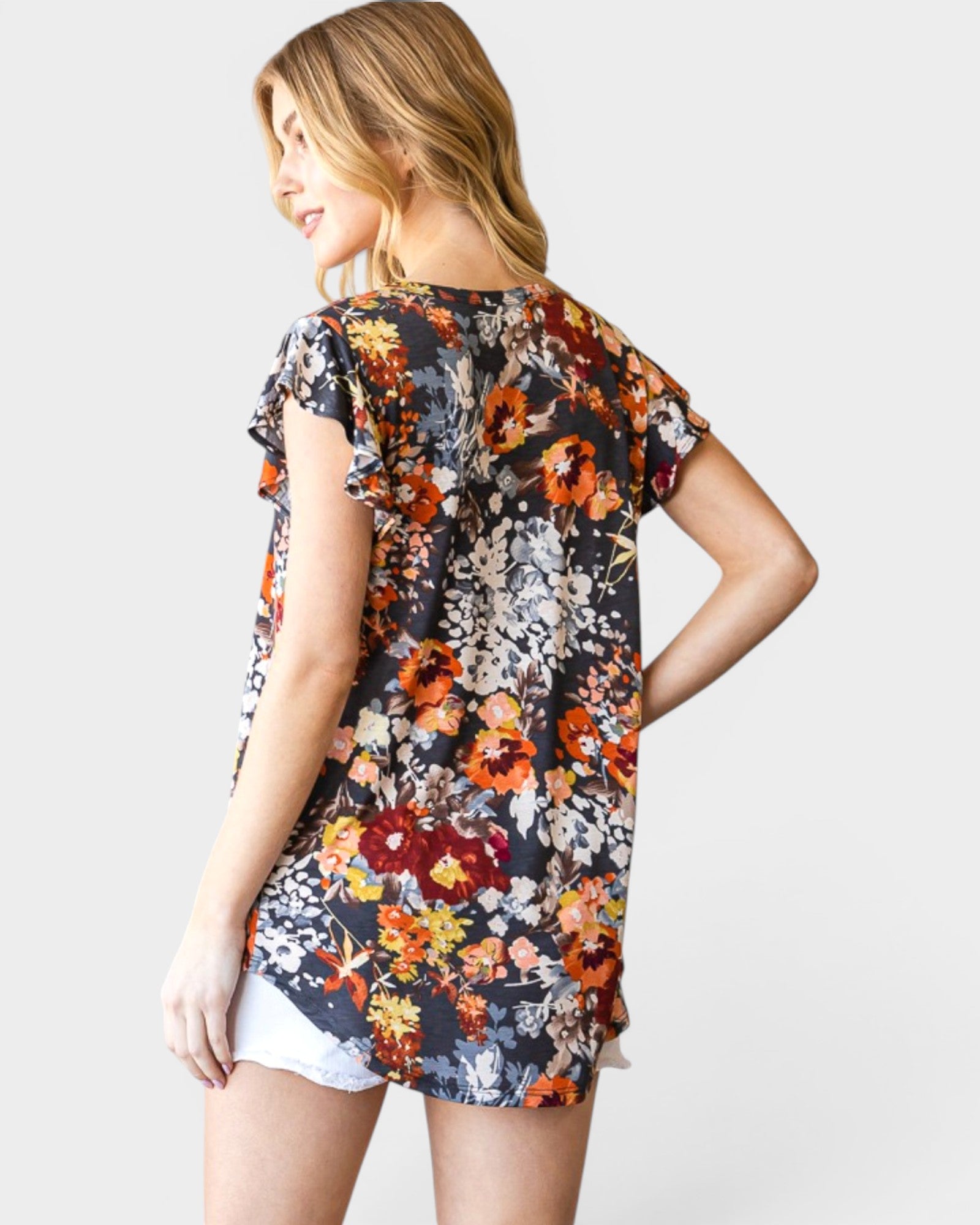 Woman wearing a floral dress with a plain background