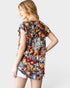 Woman wearing a floral dress with a plain background