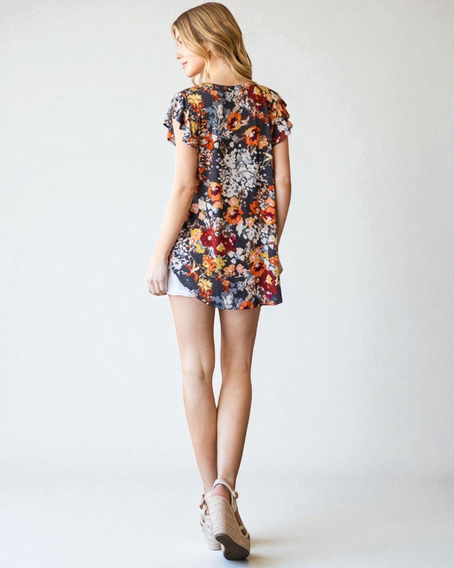 Woman wearing a floral dress on a white background