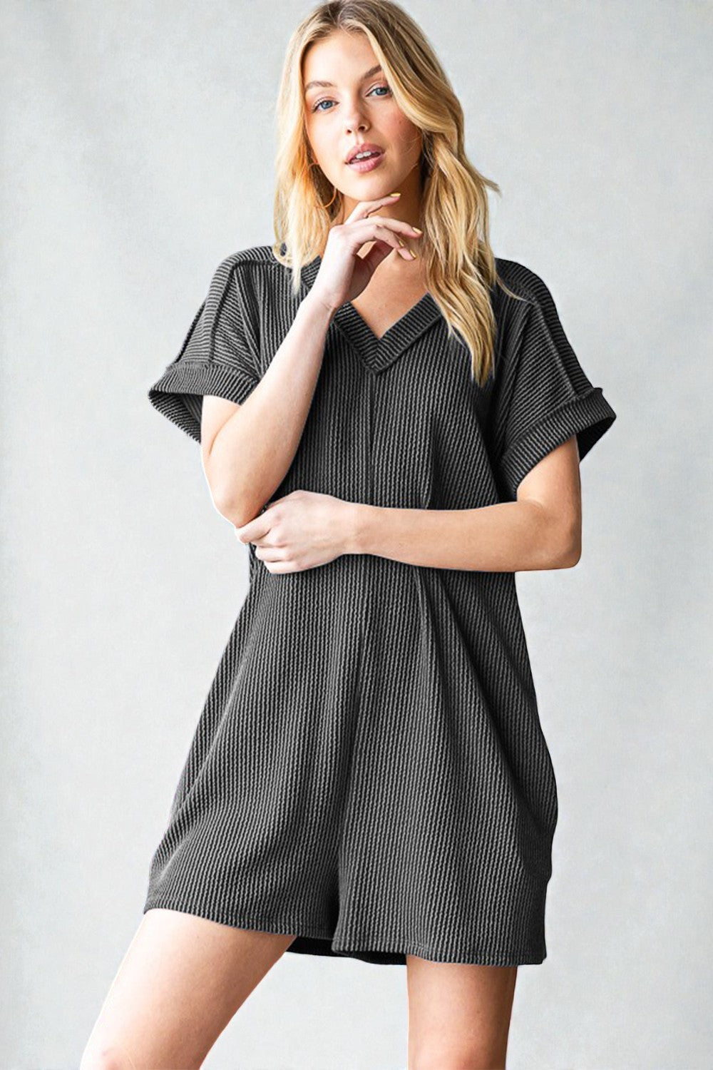 Woman wearing a black and white checkered dress against a plain background