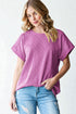 Woman wearing a purple t-shirt and blue jeans on a white background