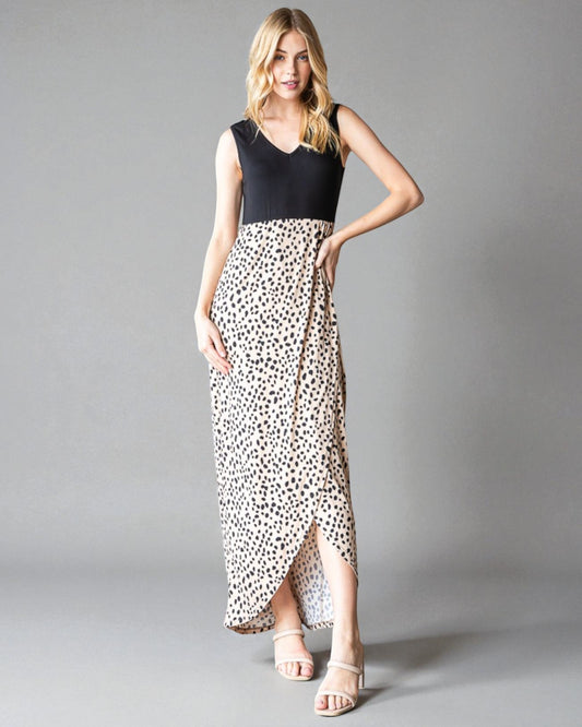 Woman wearing a black top and leopard print skirt on a gray background