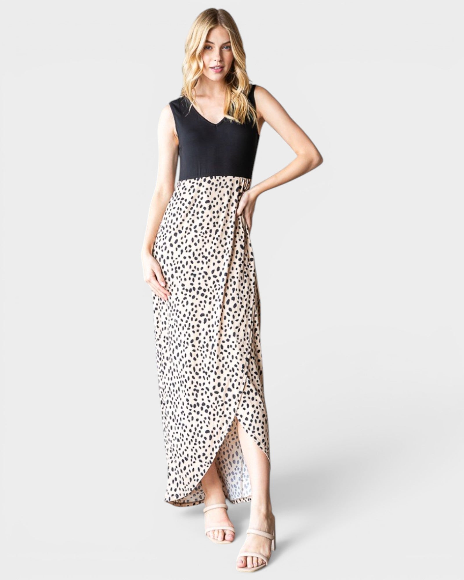 Woman wearing a dress with a black top and leopard print skirt on a white background