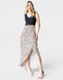 Woman wearing a dress with a black top and leopard print skirt on a white background