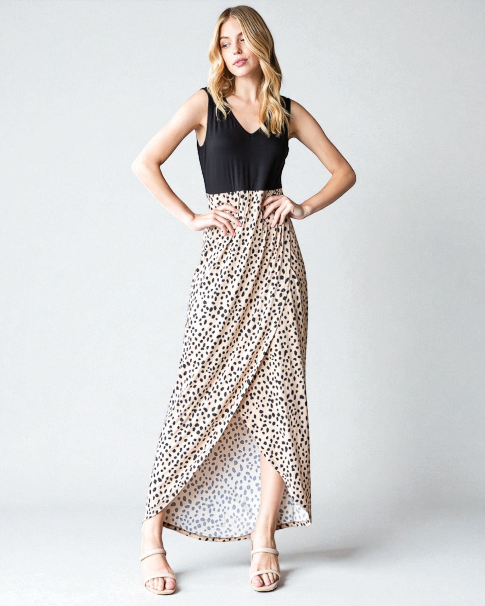 Woman wearing a black top and leopard print skirt on a white background