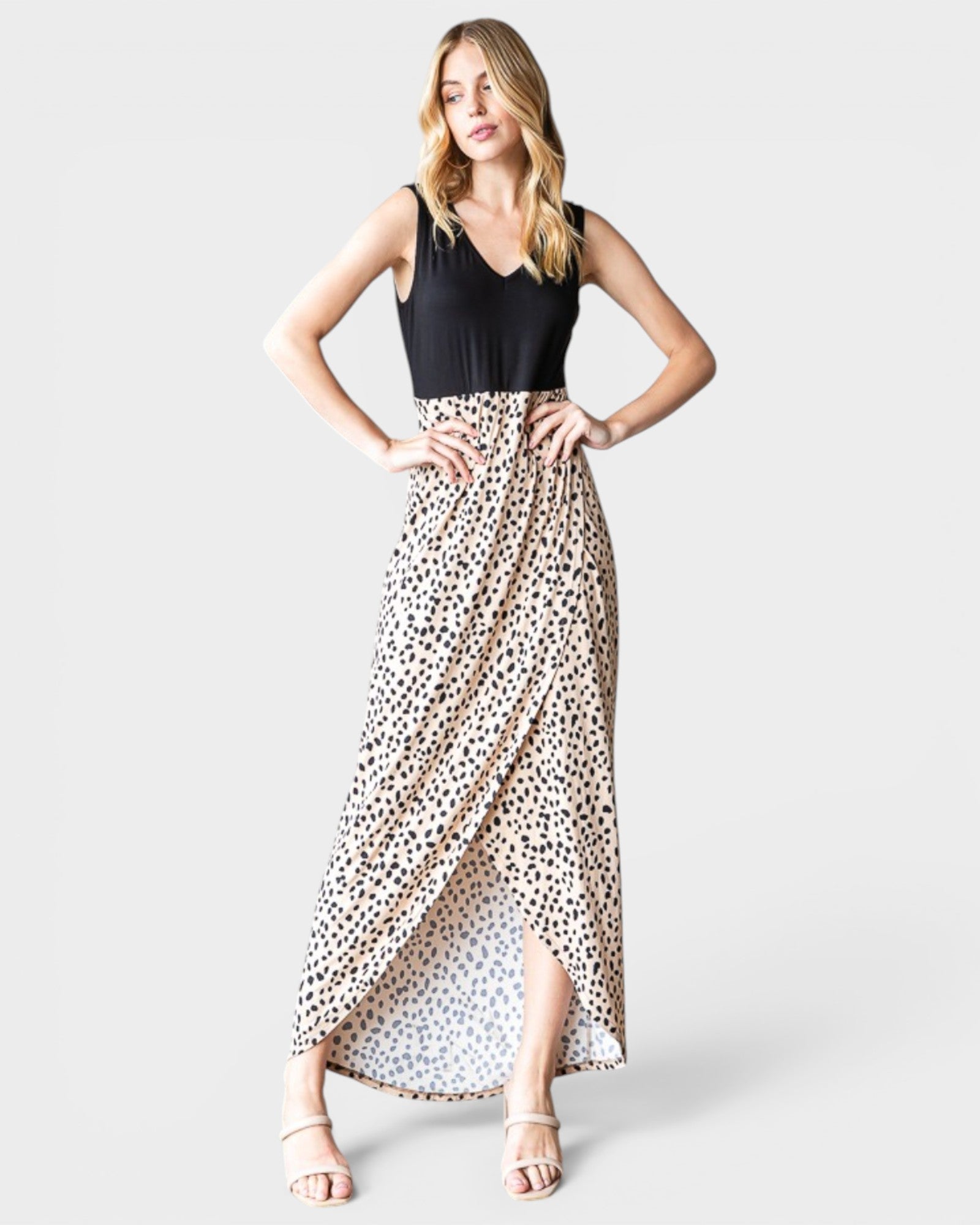 Woman wearing a dress with a black top and leopard print skirt on a white background