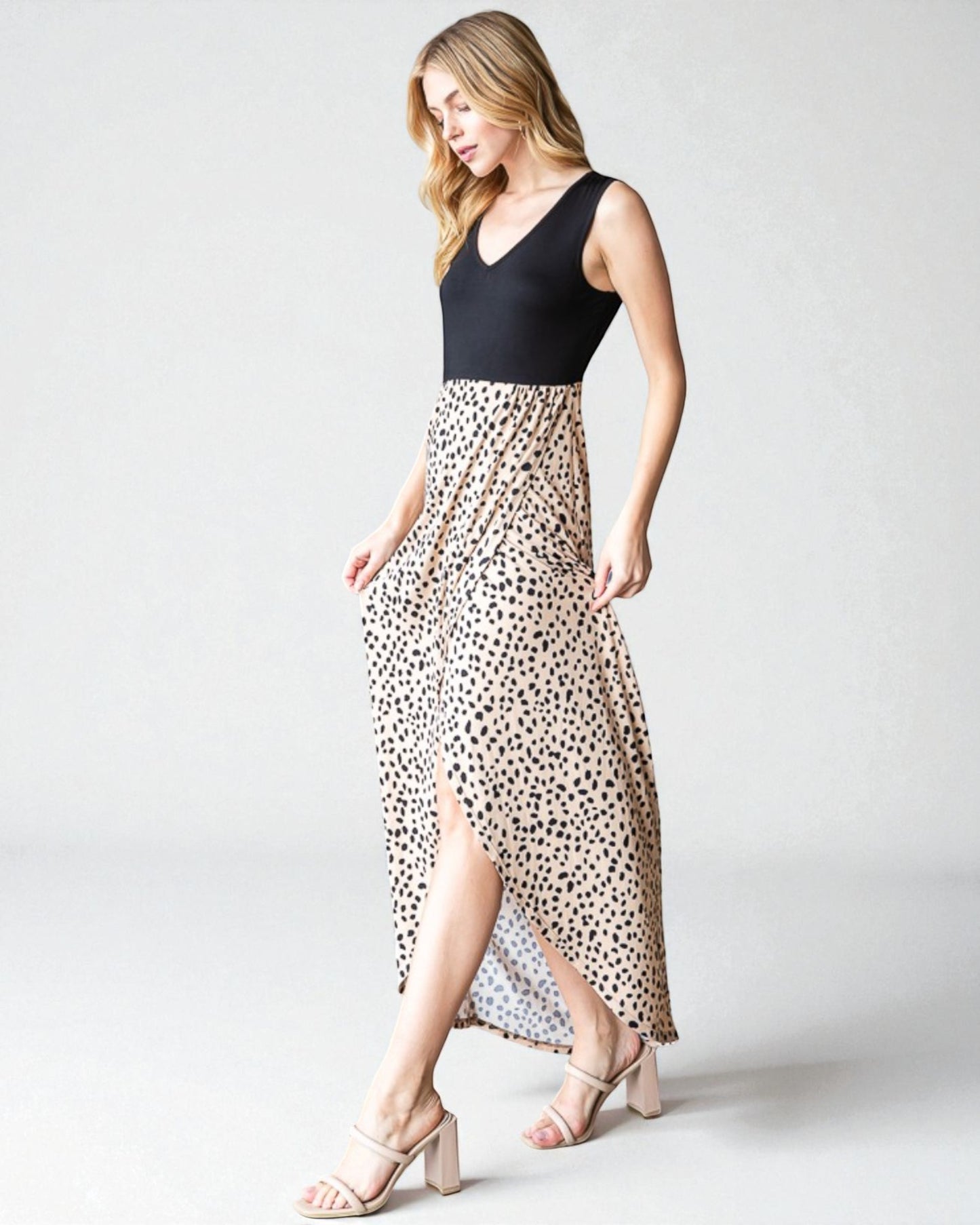 Woman wearing a black top and leopard print skirt on a white background