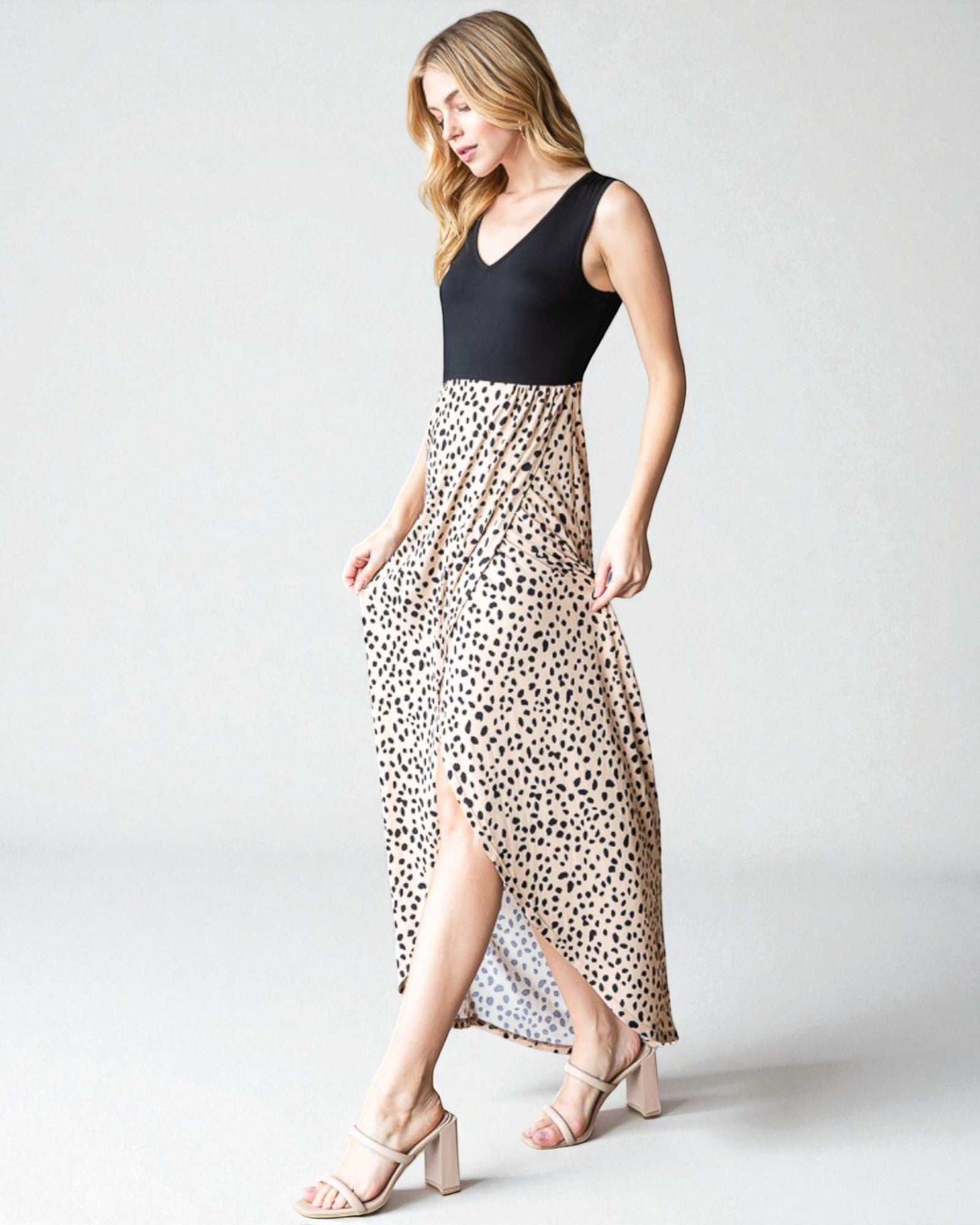 Woman wearing a black top and leopard print skirt on a white background