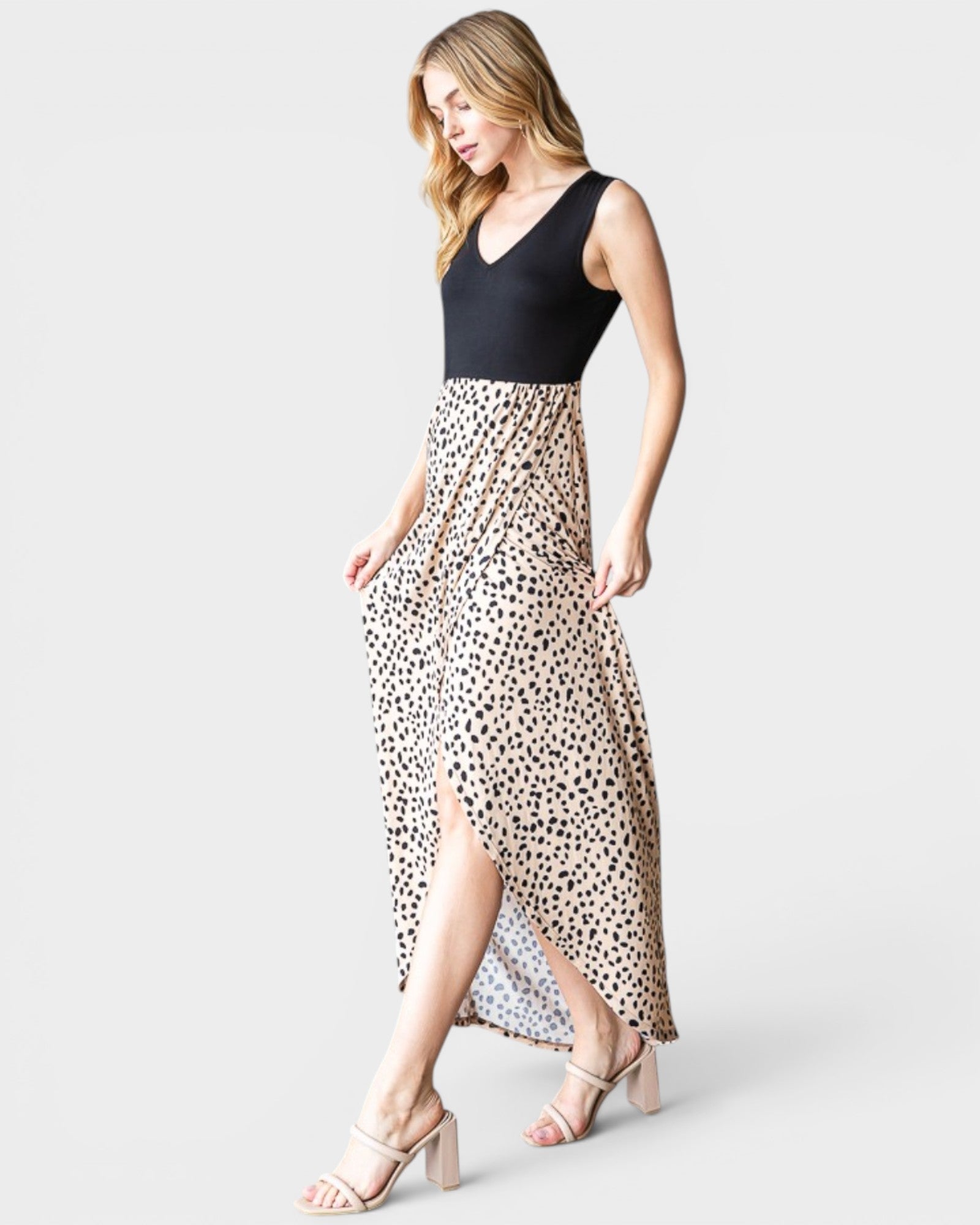 Woman wearing a dress with a black top and leopard print skirt on a white background