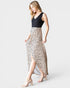 Woman wearing a dress with a black top and leopard print skirt on a white background