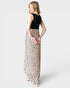 Woman wearing a dress with a black top and leopard print skirt on a white background
