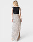 Woman wearing a dress with a black top and leopard print skirt on a white background