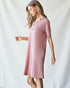 Woman wearing a pink dress against a white background