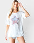 Woman wearing a white t-shirt with a star design on a plain background