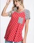 Woman wearing a red shirt with white star pattern and black and white striped sleeves on a white background