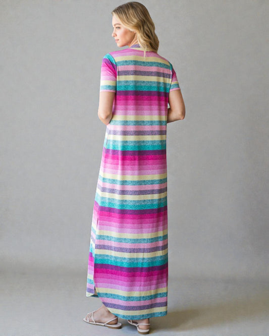 Woman wearing a colorful striped dress against a plain background