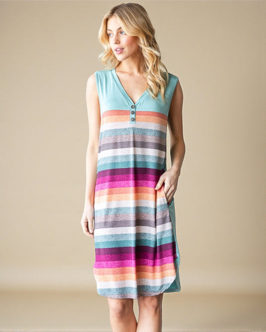 Woman wearing a colorful striped dress against a beige background