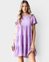 Woman wearing a purple dress against a white background