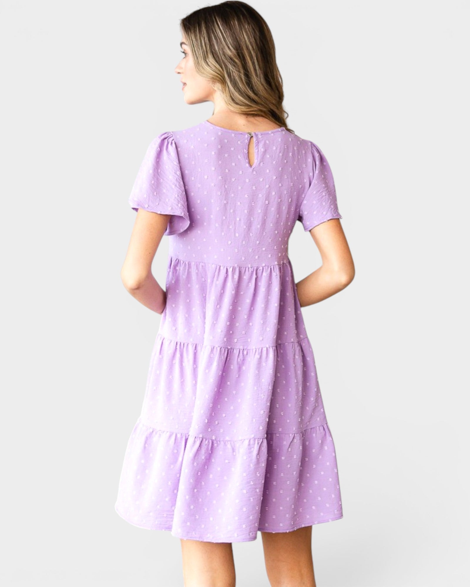 Woman wearing a purple dress on a white background