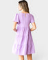 Woman wearing a purple dress on a white background