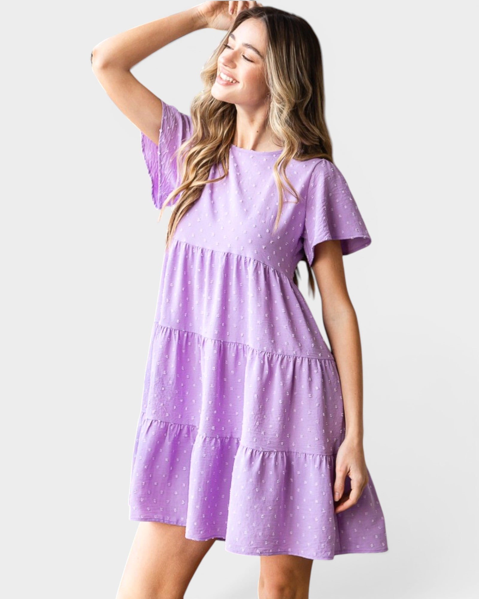 Woman wearing a purple dress against a white background