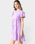 Woman wearing a purple dress against a white background