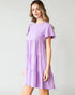 Woman wearing a purple dress with a white background