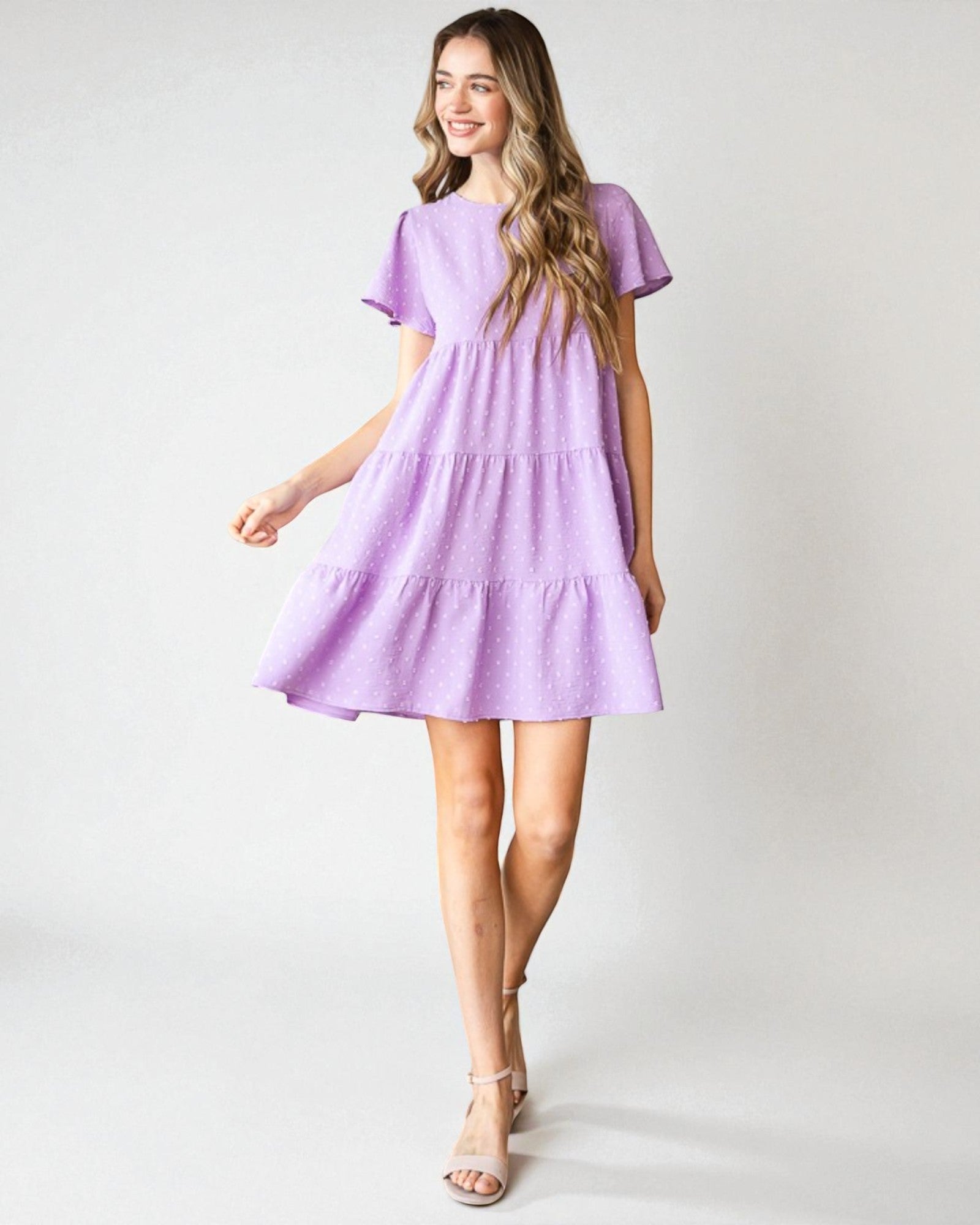 Woman wearing a purple dress on a white background