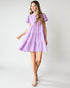Woman wearing a purple dress on a white background