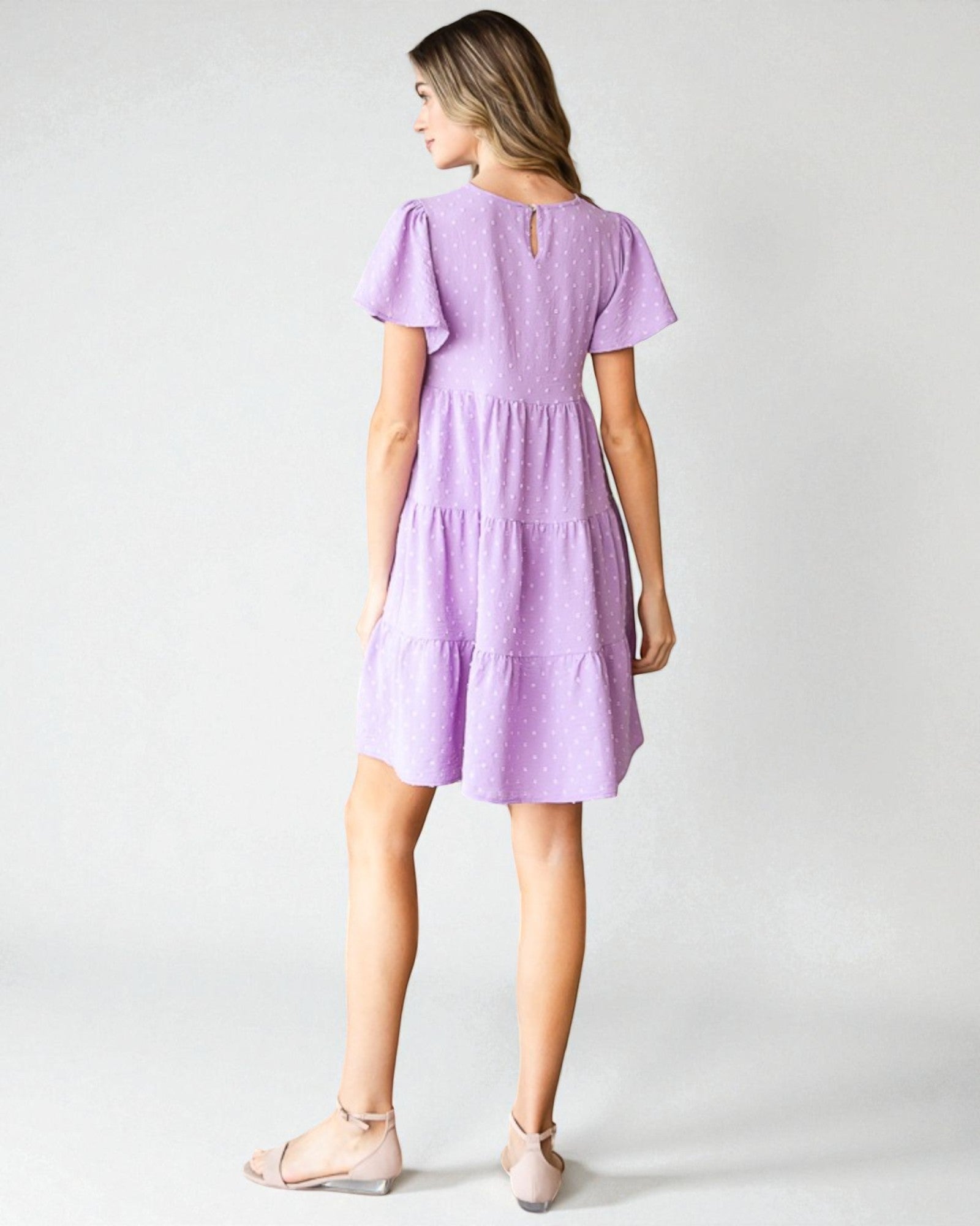 Woman wearing a purple dress on a white background