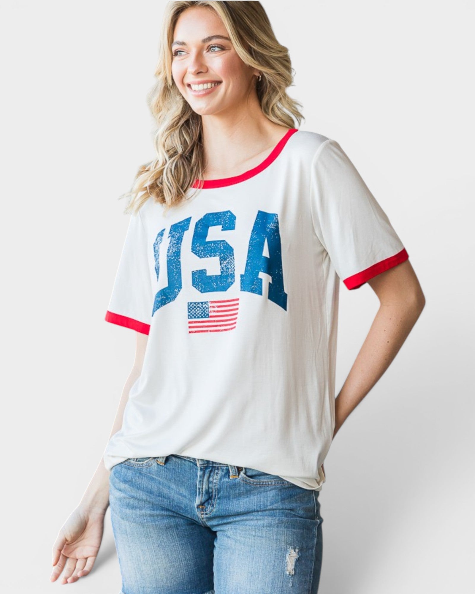 Woman wearing a white t-shirt with 'USA' and an American flag design on a plain background