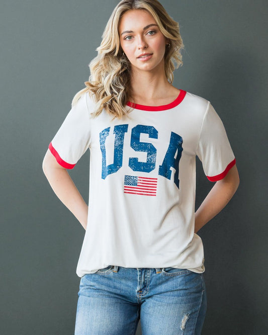 Woman wearing a white t-shirt with 'USA' and an American flag design on a gray background