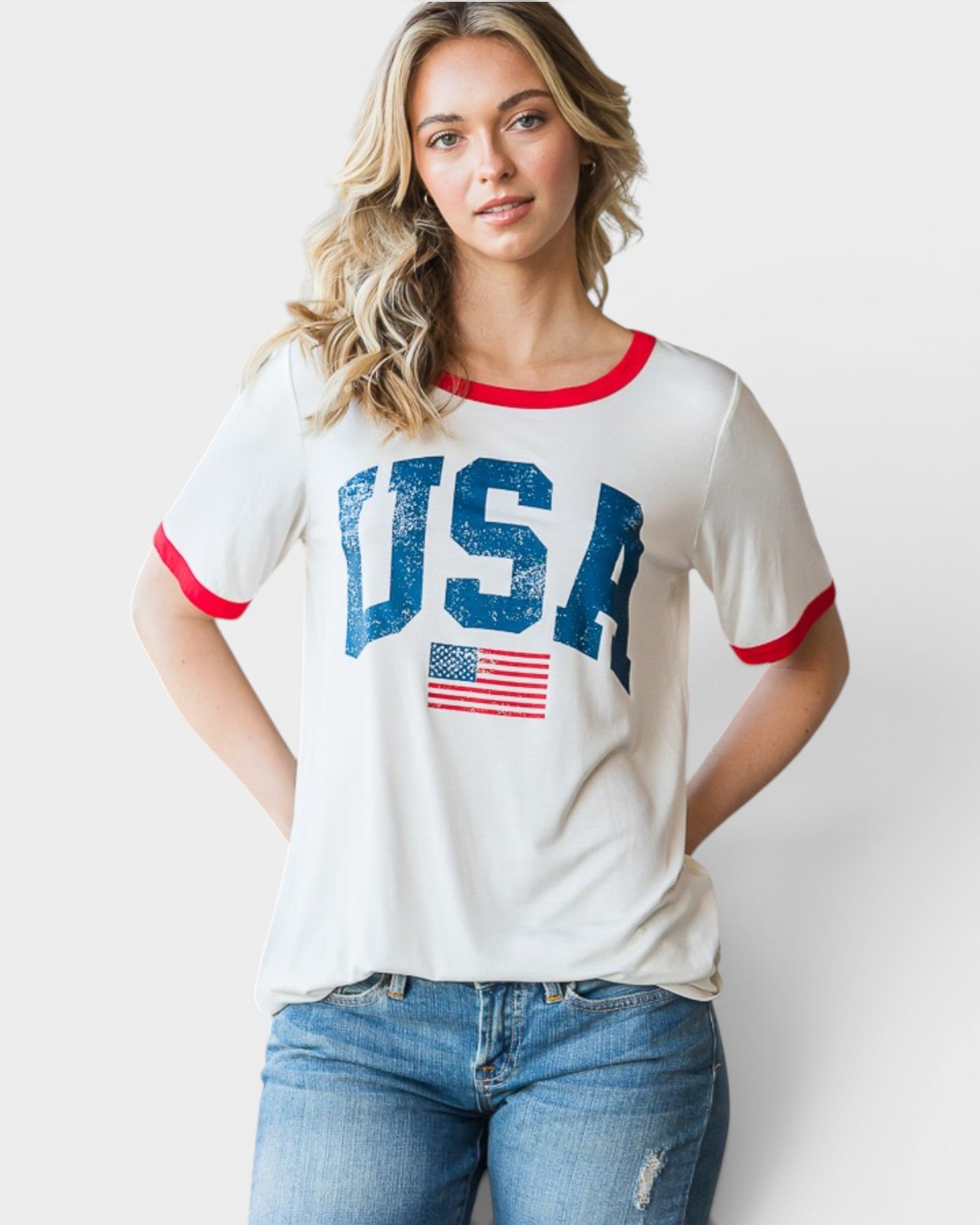 Woman wearing a white t-shirt with 'USA' and an American flag design on a plain background