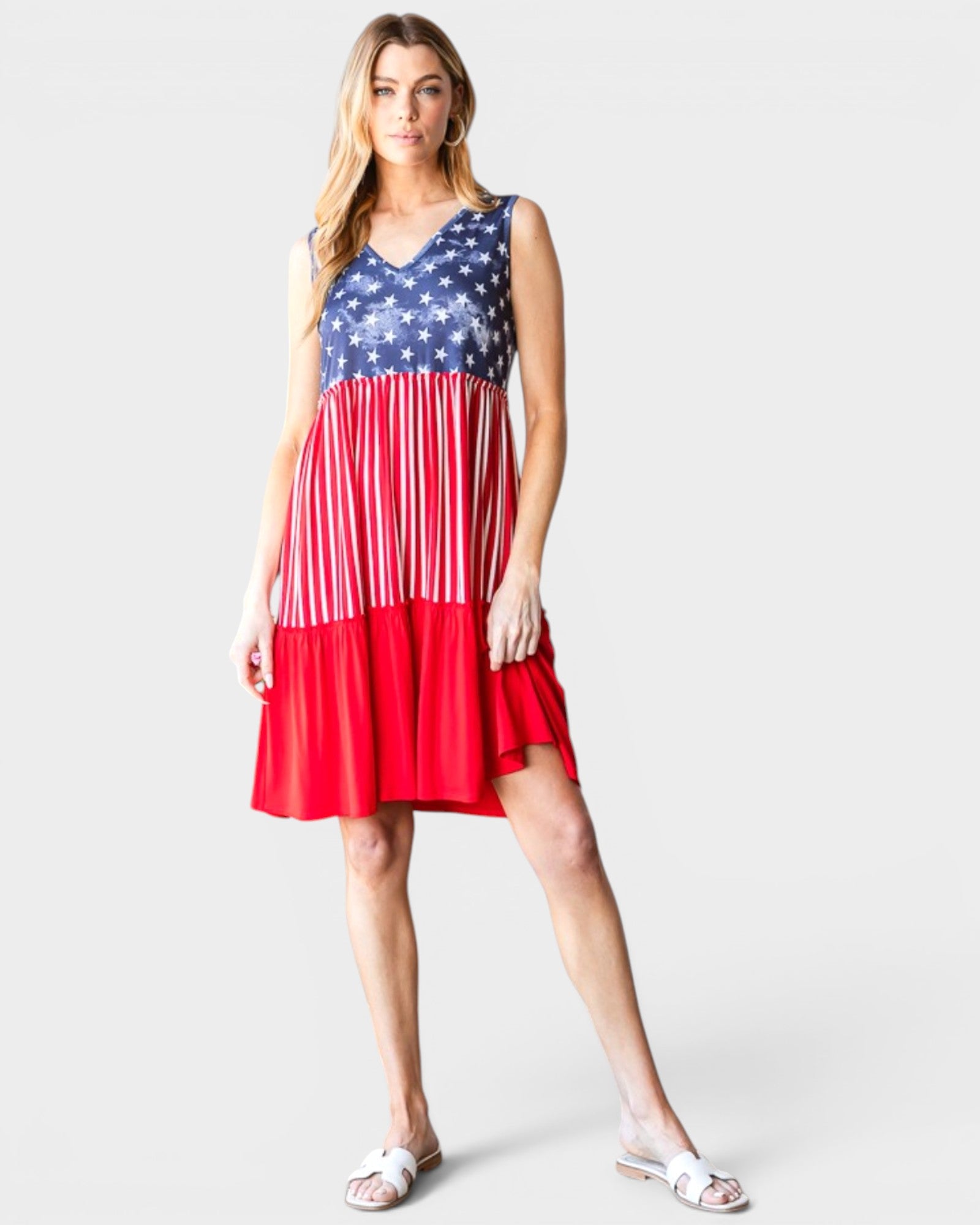 Woman wearing a dress with American flag pattern on a white background