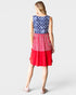 Woman wearing a dress with American flag pattern on a white background