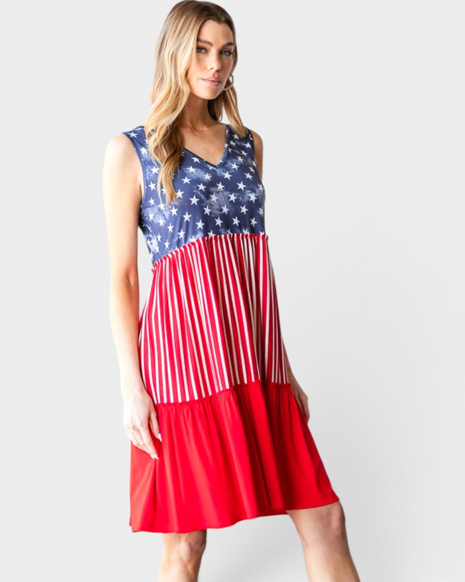 Woman wearing a dress with American flag design on a plain background